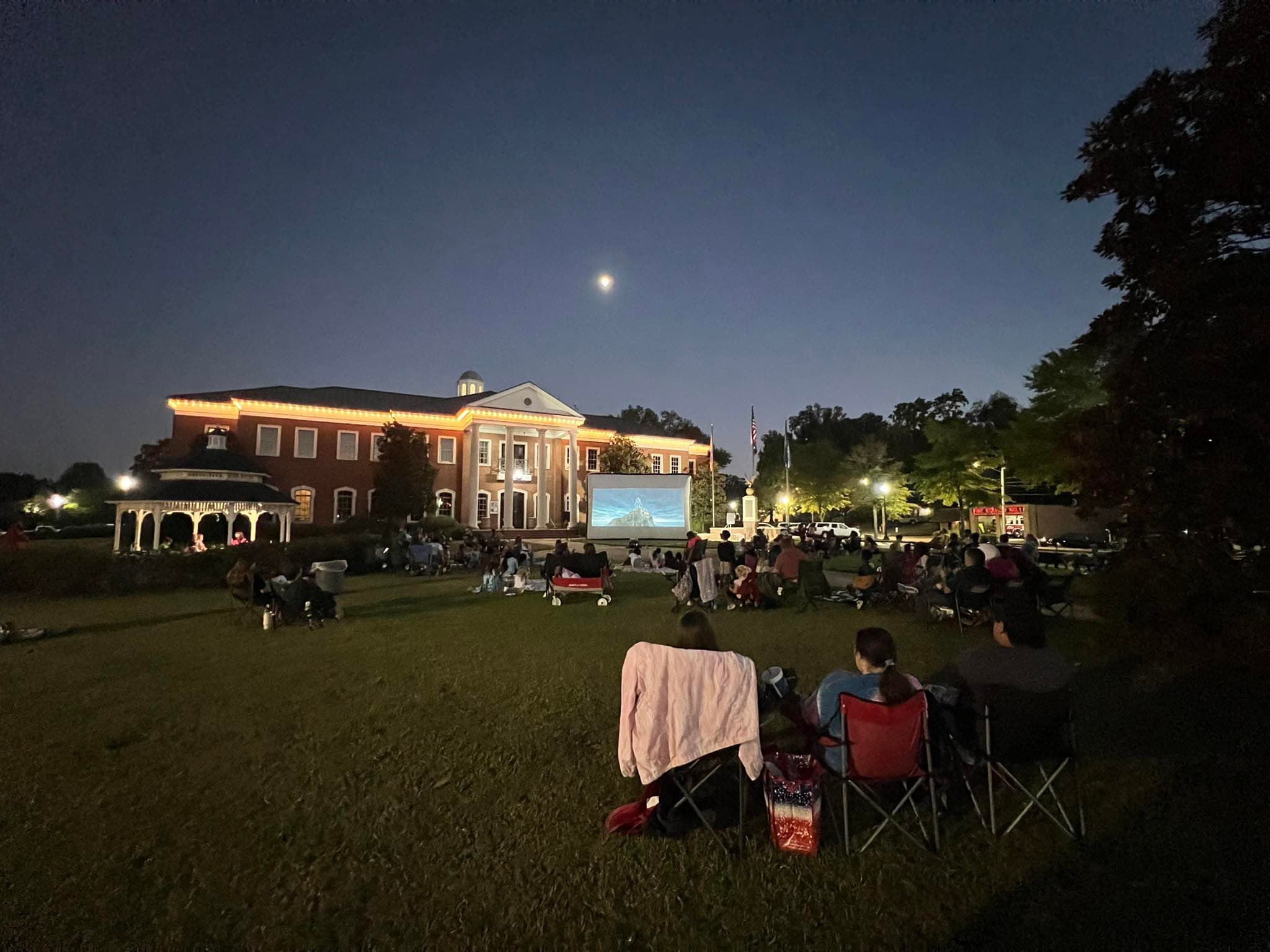 Families gathered on the lawn for an outdoor movie night at Hernando Courthouse Square