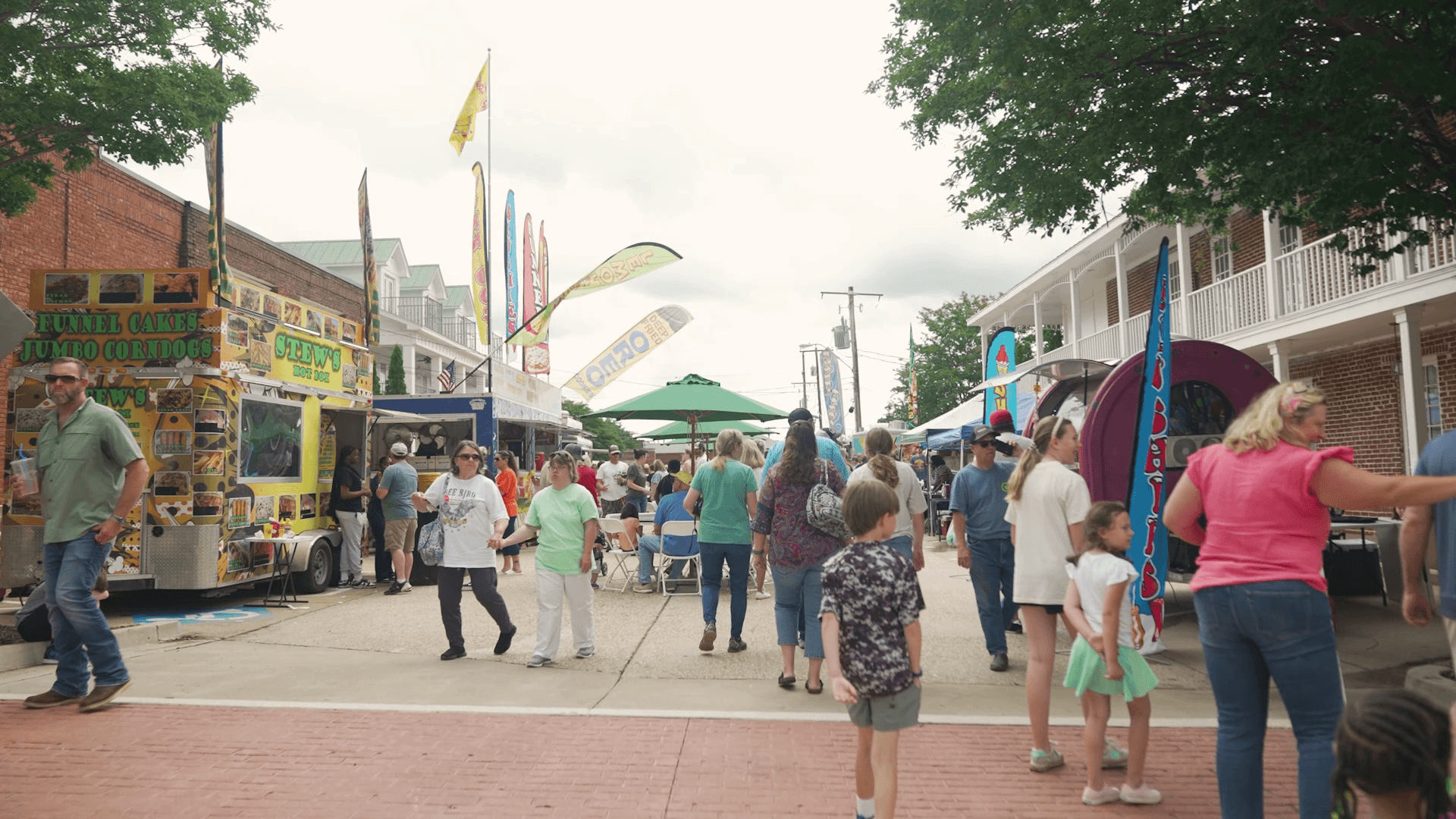 Street festival with food vendors and crowds in downtown Hernando